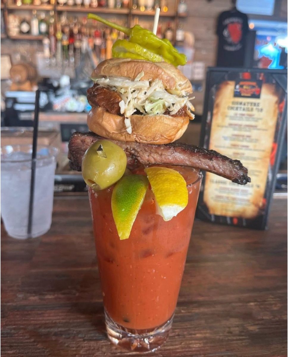 Bloody Mary cocktail topped with a mini brisket sandwich, pepper, and barbecue garnish at Rick’s Rollin Smoke BBQ in Las Vegas.